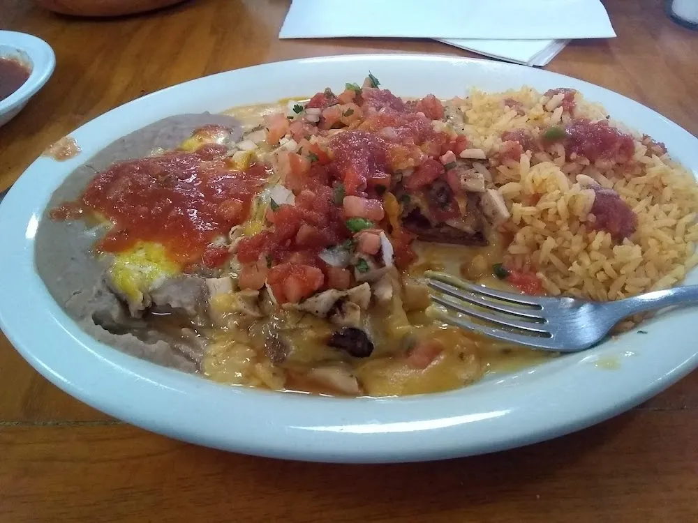 The Number 10 Lunch Special Two Cheese Enchiladas with Spicy Queso and Chicken Fajaita on Top